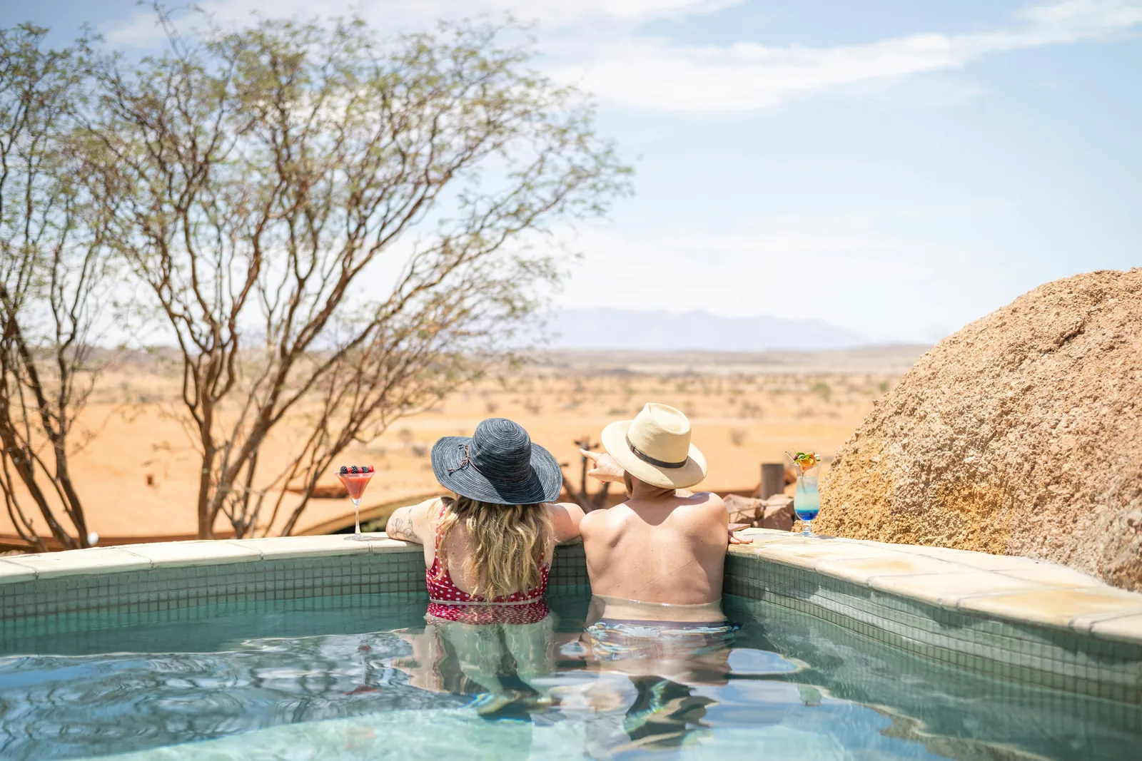 Couple in a plunge pool overlooking the Kenyan plains